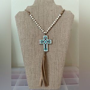 Beaded gold tone cross with leather strap and tassel. 25” long. Never worn.